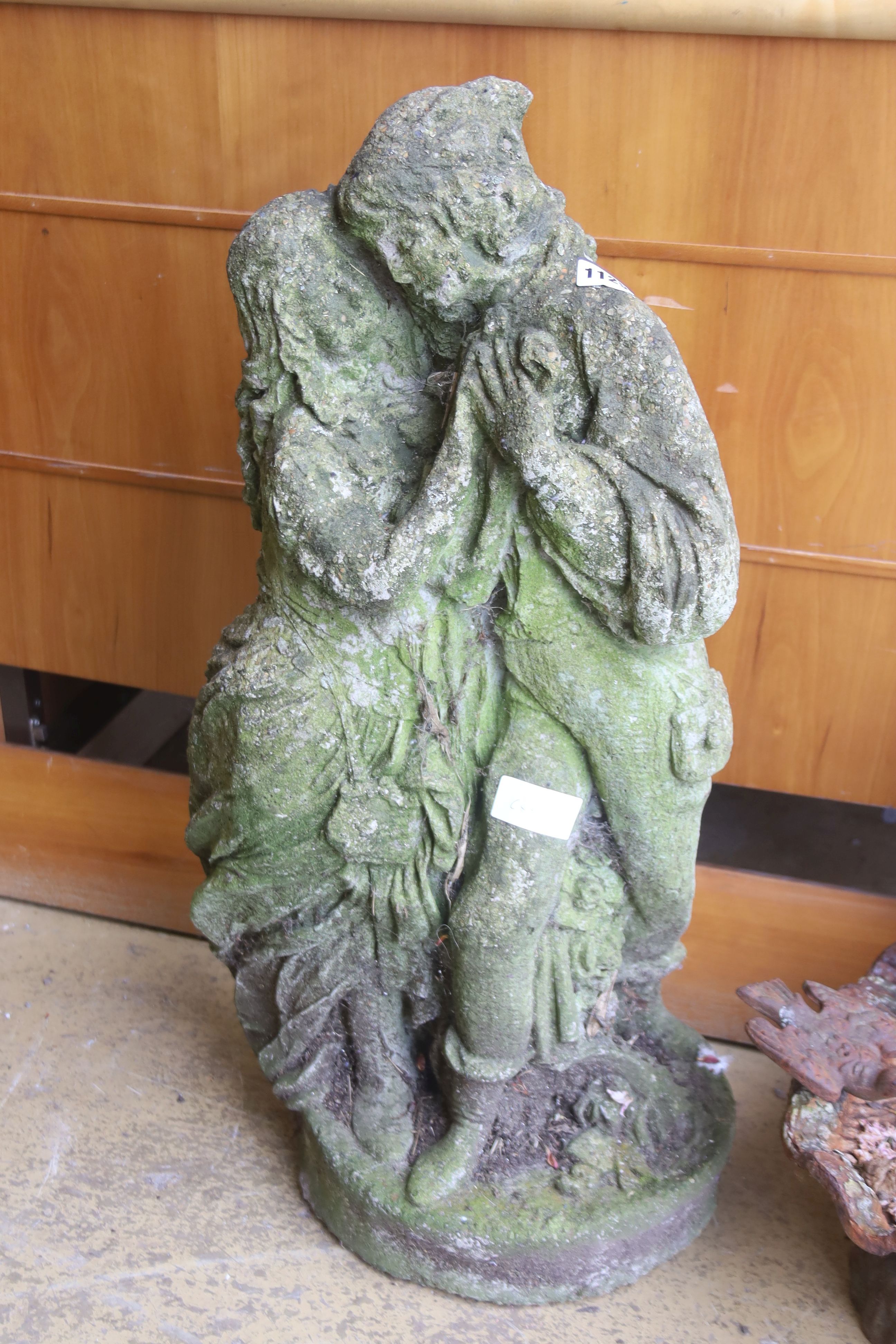 A reconstituted stone garden ornament of a couple, height 72cm
